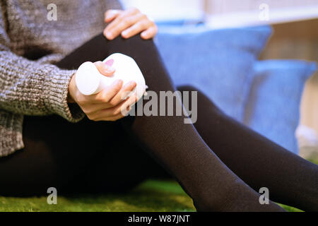 relax and massage, electric knee and leg massage machine on women leg, closeup, healthcare and medicine concept Stock Photo