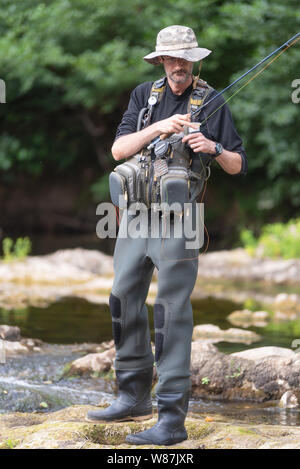 Pro fishermen with fishing rod, hobby and sport activity Stock Photo - Alamy