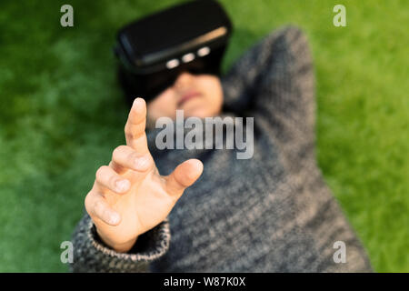 woman wearing virtual reality glasses. Smartphone using with VR headset Stock Photo