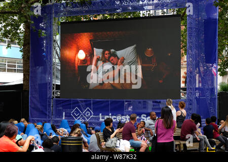 Leicester Square, London, UK. 8th August 2019. People watching a free open air screening of Mamma Mia – Here we go again! at the Leicester Square Summer Screenings. Credit: Matthew Chattle/Alamy Live News Stock Photo