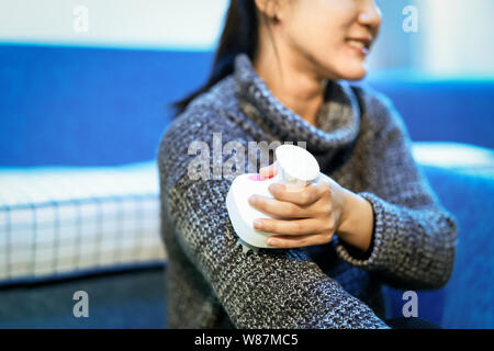 relax and massage, electric arm, neck and shoulder massage machine on women arm, closeup, healthcare and medicine concept Stock Photo