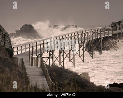 Wooden bridge over troubled waters. Photo composition. Stock Photo