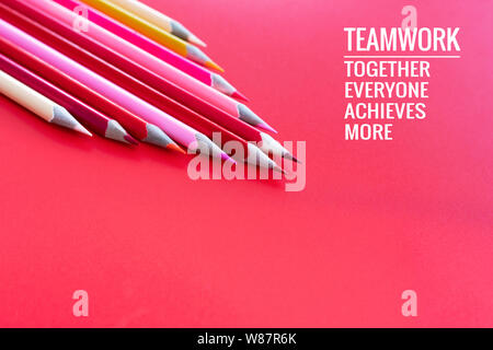 Teamwork concept. group of color pencil on pink background with word Teamwork, Together, Everyone, Achieves and More Stock Photo