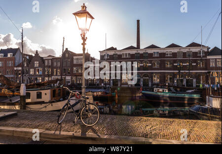 Old historic district Delfshaven with houseboats and traditional Dutch bike in Rotterdam, South Holland, The Netherlands Stock Photo