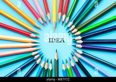 Idea sharing concept, multicolored pencils on blue background Stock Photo