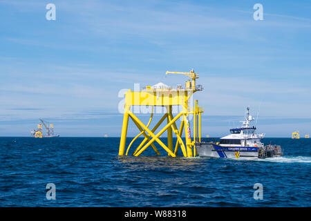 East Anglia ONE Offshore Wind Farm during construction with the heavy-lift construction vessel, Boka Lift, lifting one of the jackets in place Stock Photo