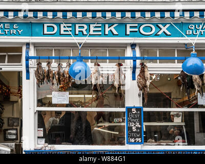 Derek Fox traditional butchers shop in Malton, North Yorkshire, with game hanging outside. Stock Photo