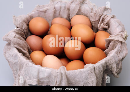 brown chicken eggs bowl on gray background, easter egg festive Stock Photo