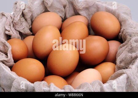 brown chicken eggs bowl on gray background, easter egg festive Stock Photo