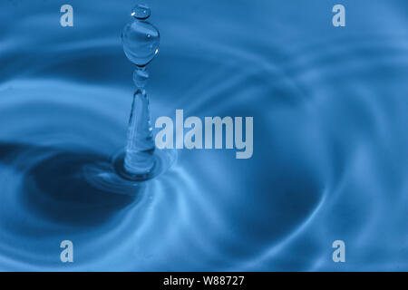 Texture, background with falling water drops and waves with blue water Stock Photo