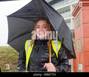 Newquay, Cornwall, UK, 08th August, 2019. Fistral Beach boardmaster crowds make for cover as torrential rain heralds severe weather warning forecast, UK. Credit: Robert Taylor/Alamy Live News. Stock Photo