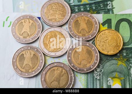 Various Euro coins on top of 100 Euro bank notes, Germany Stock Photo