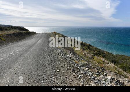 Coastal road, gravel road in Tierra del Fuego, between Porvinier and Ushuaia, border to Chile, Argentina Stock Photo