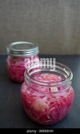 Homemade pickled onions in glass jars. Stock Photo
