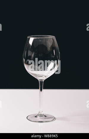 Empty wineglass close up isolated on a black and white background Stock Photo