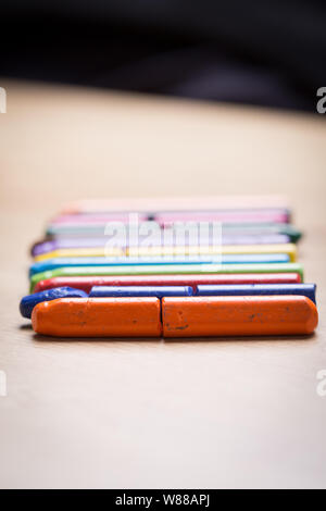 Colourful crayons on a wooden background Stock Photo