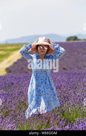 A young asian woman in the lavender fields of southern France. Stock Photo