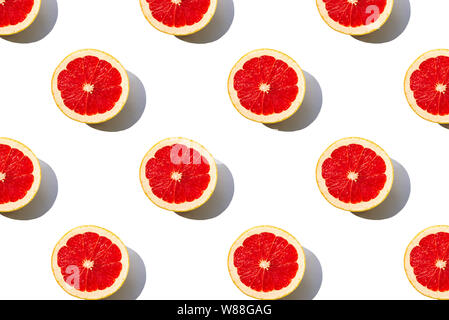 Grapefruit slices pattern isolated on white background. Minimal flat lay concept. Stock Photo