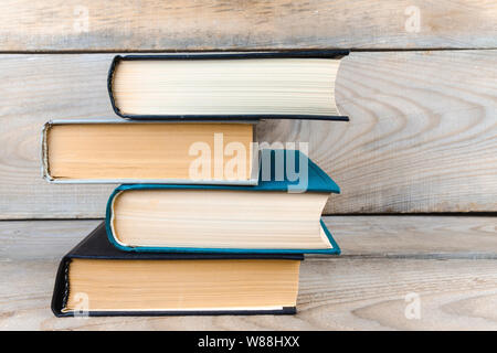 old books on an old, large wooden shelf. Stock Photo