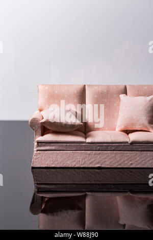 Pink small toy sofa isolated on a black and white background Stock Photo