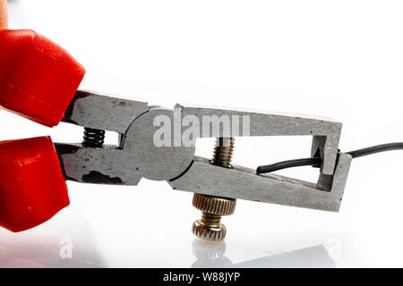 Insulated wire strippers set of electric cables on blue background electricity concept. Stock Photo