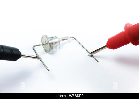 Testing diode bridge with multimeter on white background Stock Photo