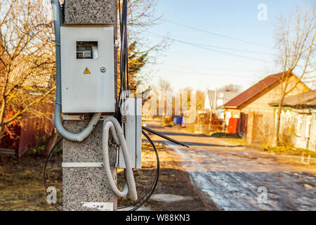 Power cabinet hanging on a pole in the village Stock Photo