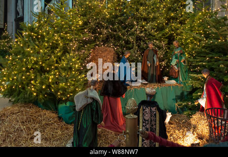 Ghent, Belgium - December 16, 2018: Nativity scene exhibit figures representing the birth of Jesus at Christmas season in Saint Bavo Cathedral. Stock Photo