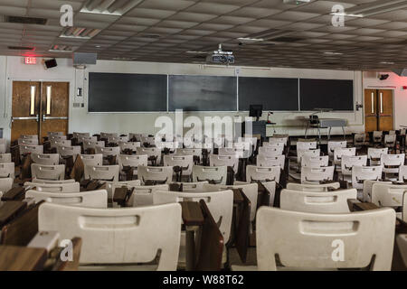 University college large classroom desk, chairs, chalk board, empty Stock Photo
