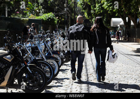 Petrópolis, April 21, 2016. Motorcyclist couple passing in front of motorcycles holding hands in the city of Petrópolis, Rio de Janeiro, Brazil Stock Photo