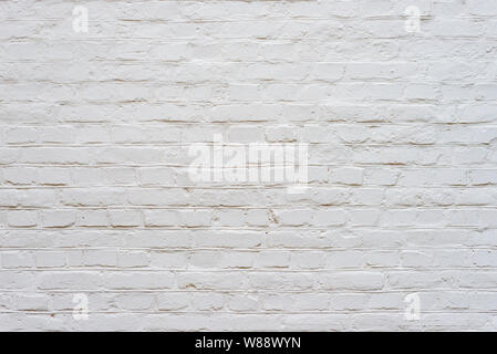 vintage bumpy, rough and old white brick texture wall with defective english brick bond pattern. Stock Photo