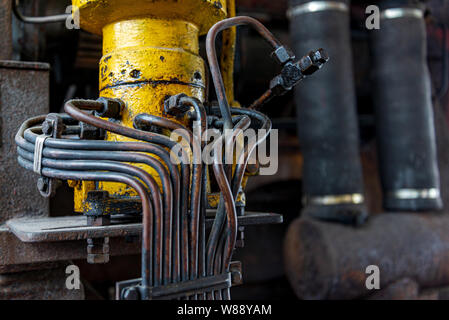 Close up view of old rusty machine with complex vault, pipeline and utilities in former coal mine industrial building at Zeche Zollverein. Stock Photo