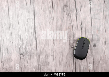 Wireless computer mouse on wooden background Stock Photo