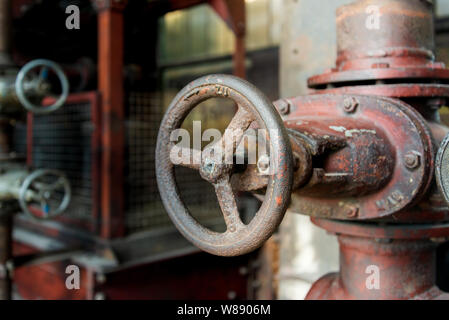 Close up view of old rusty machine with complex vault, pipeline and utilities in former coal mine industrial building at Zeche Zollverein. Stock Photo