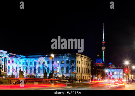 Night scenery of street and historical area around Humbolt university building and background of Berliner Fernsehturm in Berlin, Germany Stock Photo