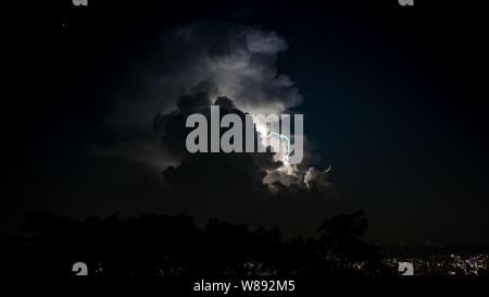 A real lightnings in the sky at night. Powerful and several lightning strikes with flashes and lights in thunderstorms. Spectacular electrical storm c Stock Photo