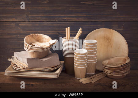Eco friendly disposable tableware on a wooden background Stock Photo
