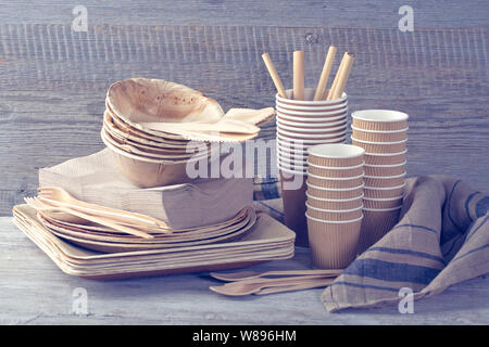 Eco friendly disposable tableware on a wooden background Stock Photo