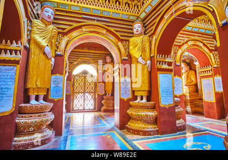 MONYWA, MYANMAR - FEBRUARY 22, 2018:  Thanboddhay Pagoda boasts outstanding interior with many decorative details, such as statues, small sculptures, Stock Photo