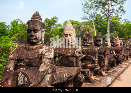 Stone faces at the entrance gate of Bayon Temple. Bayon is a well known khmer temple at Angkor in Cambodia. Stock Photo