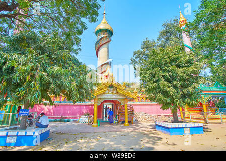 MONYWA, MYANMAR - FEBRUARY 22, 2018: Observe impressive watchtower of Arlain Nga Sint shrine of Thanboddhay Monastery with spiral staircase and golden Stock Photo