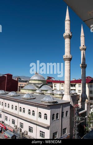 A stork with its cubs and the nest on the dome of a mosque in the city of Igdir, capital of Igdır Province in the Eastern Anatolia Region of Turkey Stock Photo