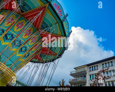 colorful merry-go-round against blue sky Stock Photo