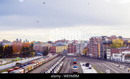 VANCOUVER, BC, CANADA - OCTOBER 28, 2018: Freight trains are parked on rail track sidings near the city's historical Gastown neighborhood. Stock Photo