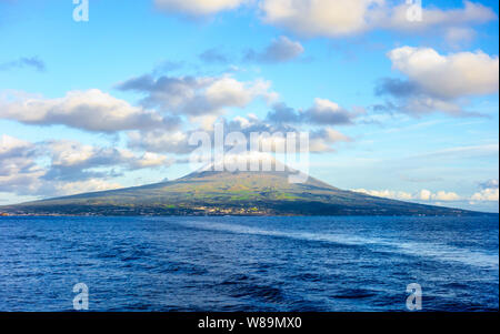 Mount Pico volcano western slope viewed from ocean with summit in clouds, in Azores, Portugal. Stock Photo