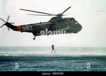 Navy rescue swimmer Mark Podzon jumps from a SH-3H Sea King helicopter into the Flores Sea in Indonesia during a man overboard drill conducted by the USS Blue Ridge (LCC 19) on Feb. 14, 2000.  Podzon is an Aviation Ordnanceman 3rd Class attached to Helicopter Anti-Submarine Light Squadron 51, deployed to the Blue Ridge from Naval Air Facility, Atsugi, Japan.  The Blue Ridge is en route to the Persian Gulf where it will join Operation Southern Watch. Stock Photo