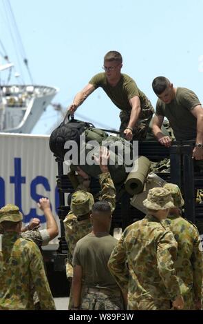 Marines of the 3rd Battalion, 3rd Marine Regiment, and soldiers of Charlie Company, 2nd Battalion, Royal Australian Army work together to unload gear as they prepare for the Rim of the Pacific Exercise 2004 with USS Tarawa (LHA 1) in Pearl Harbor, Hawaii, on July 5, 2004.  Rim of the Pacific is an international exercise that enhances the joint cooperation and proficiency of maritime and air forces of Australia, Canada, Chile, Peru, Japan, Republic of Korea, the United Kingdom and the United States. Stock Photo