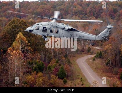 An MH-60S Knighthawk helicopter flies over Fort Knox, Ky., on Oct. 20, 2004.  The Navy helicopter is assigned to Helicopter Combat Support Squadron 6 and is conducting combat search and rescue operation training exercises in the Fort Knox area. Stock Photo