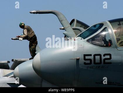 A sailor assigned to the Electronic Attack Squadron 130 cleans the aerial fueling probe of an EA-6B Prowler prior to flight operations on the flight deck of the USS Harry S. Truman (CVN 75) while underway in the Persian Gulf on March 17, 2005.  The Truman Strike Group and Carrier Air Wing 3 are conducting close air support, intelligence, surveillance, and reconnaissance missions over Iraq. Stock Photo