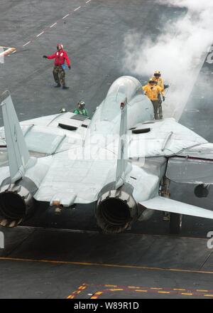 A Navy F-14D Tomcat is being directed to the catapult for launch from the flight deck of the USS Theodore Roosevelt (CVN 71) on June 25, 2005.  Roosevelt is currently underway in the Atlantic Ocean for a composite training unit exercise.  The Tomcat is attached to Fighter Squadron 213, which is deployed aboard the Roosevelt from Naval Air Station Oceana, Va. Stock Photo